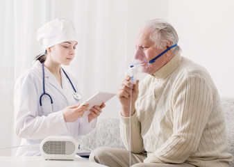 doctor does inhalation elderly man