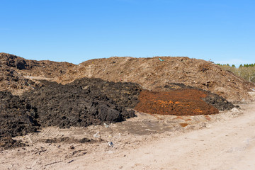 Piles of soil deposits at landfill over old dump. - 144062416