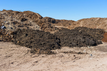 Piles of soil deposits at landfill over old dump. - 144062424