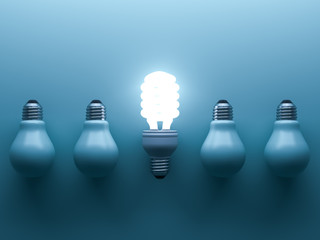 Energy saving light bulb up , one glowing fluorescent lightbulb standing out from unlit down incandescent bulbs on blue background , individuality and different creative idea concepts . 3D rendering.