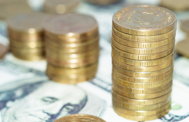 Stack of coins on dollars background