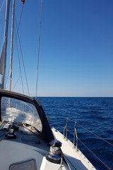 Fototapeta premium Yacht sails on the blue sea