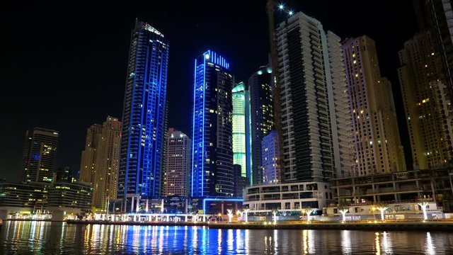 UHD 4K Dubai Marina night time lapse, United Arab Emirates. Dubai Marina - the largest man-made marina in the world. Dubai Marina is a canal city, carved along a 3 km stretch of Persian Gulf shoreline