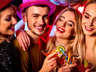 Cocktail party with group people dancing and drink cocktail. Women and men have fun in night club....