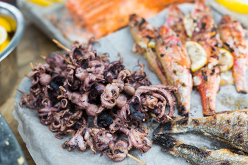 Seafood, fish, octopus grilled at barbecue