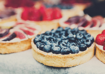 Fruit and berry tarts dessert tray assorted outdoors