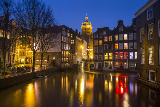 The buildings reflected in the canals of Amsterdam Damrak. Netherlands - Europe