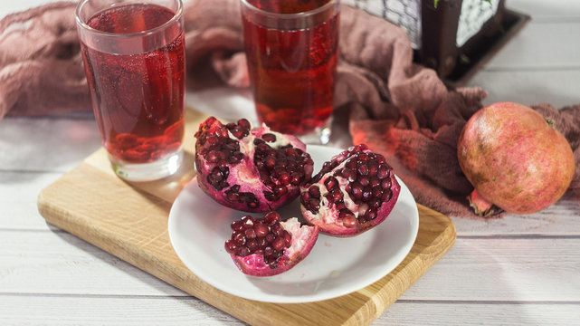 Pomegranate juice in a glass and ripe pomegranate