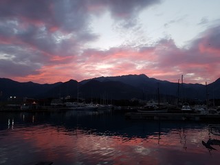 Yachts in the marina at sunrise against the backdrop of the mountains