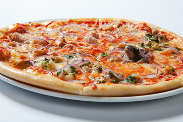 Pizza with onion, ham, cheese and tomato. White background
