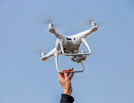 Hand catch of drones with female arms
