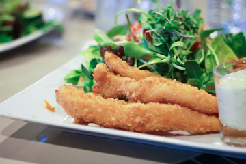 Fried fish, french fries and Vegetable salad.