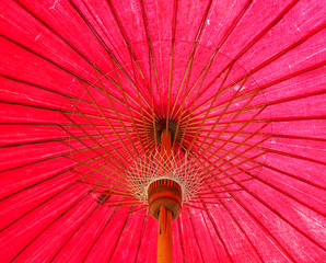 Under red Thai traditional paper umbrella