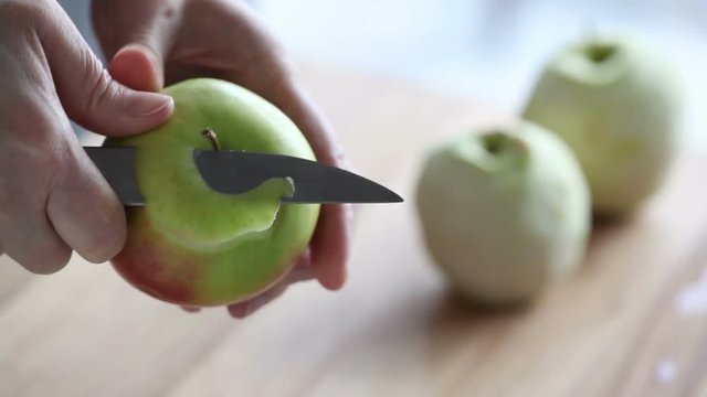Video Peeling of apple on the wood background