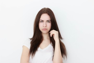 Fototapeta premium Young casual woman In pink blouse isolated over white background studio portrait