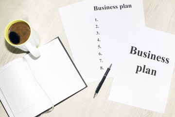 An inscription of the business plan, execution points, there is a notebook and a calculator next to it