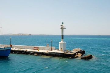 Small lighthouse among the Cycladic Islands. In the Aegean sea. Greece. This place is whittling its simplicity. And very beauty of the sea landscape. From travels in Mediterranean
