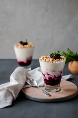 Delicious Breakfast in a glass with granola, yogurt and berries