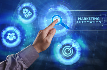 Business, Technology, Internet and network concept. Young businessman working on a virtual screen of the future and sees the inscription: Marketing automation