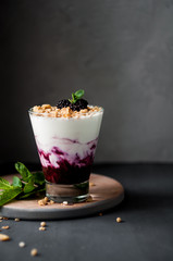 Dessert with blackberries, yogurt and granola in the glass. Healthy Breakfast