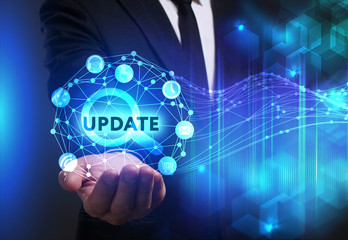 Business, Technology, Internet and network concept. Young businessman working on a virtual screen of the future and sees the inscription: Update