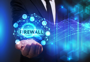 Business, Technology, Internet and network concept. Young businessman working on a virtual screen of the future and sees the inscription: Firewall