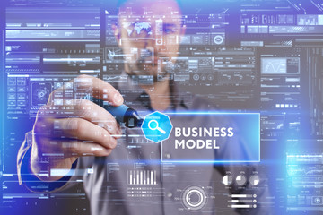 Business, Technology, Internet and network concept. Young businessman working on a virtual screen of the future and sees the inscription: Business model