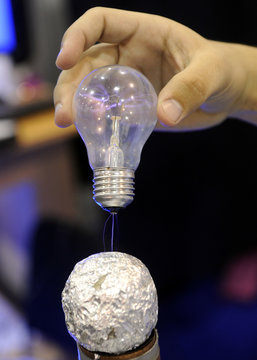 Light bulb sparks in hand