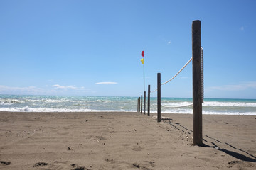 beach fence and safe bathing flag