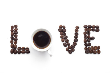 Word love made of beans over white background.