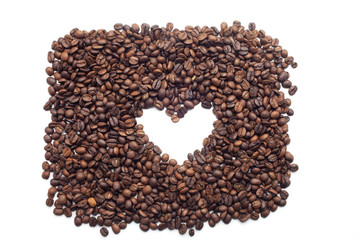 Heart shape made of Coffee beans over seeds background
