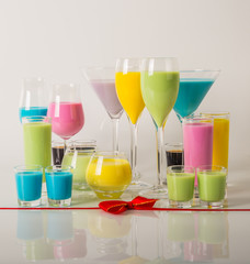 Colorful drinks based on milk liqueurs, unique pastel colors of drinks in different glasses, spring drinks