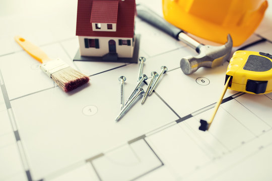 close up of house blueprint with building tools