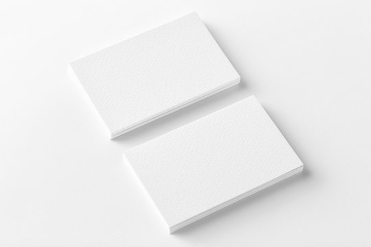 Mockup of two horizontal business cards stacks at white textured background. Angle view