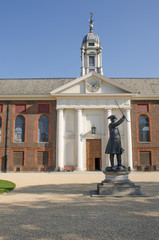 Front of Royal Chelsea Hospital with pensioner statue at  entrance