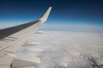 Obraz premium view from the airplane window to the clouds