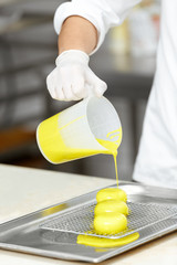 Handsome male cook preparing delicious pastry