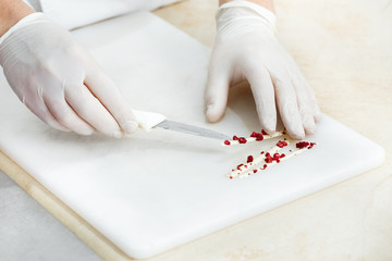 Obraz na płótnie Canvas Male chef preparing decorations for his pastry