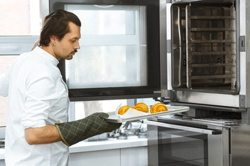 Mature baker at his kitchen