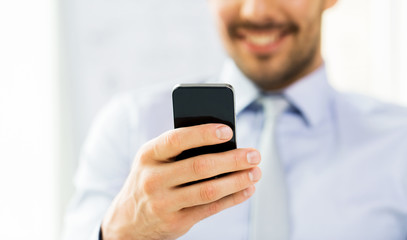 Obraz na płótnie Canvas close up of businessman with smartphone