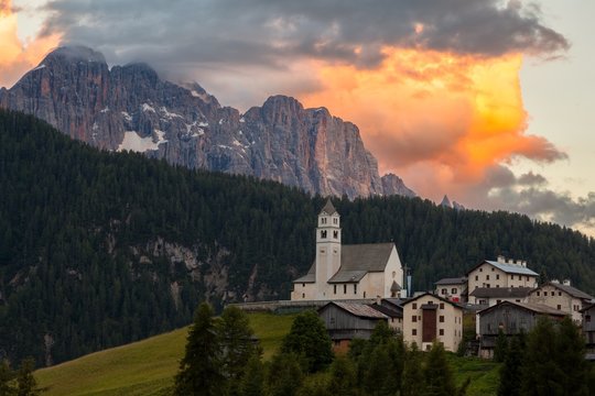 The village of Colle Saint Lucia, Belluno, perched on a green hill, Dolomites, Italy.