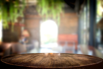 Selected focus empty brown wooden table and coffee shop cafe or restaurant blur background image. for your photomontage or product display