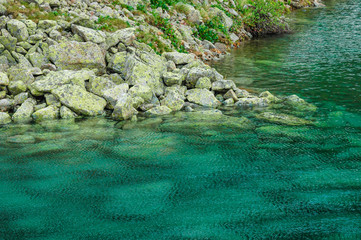 Blue transparent water and stones