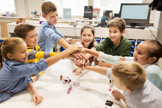 happy children holding hands at robotics school
