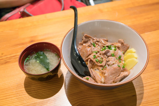 japanese Grilled Pork Rice Bowl on wooden table
