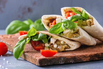 Pita bread sandwiches with grilled vegetables paprika, eggplant, tomato, basil and feta cheese...