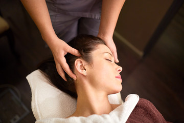 woman having head massage at spa