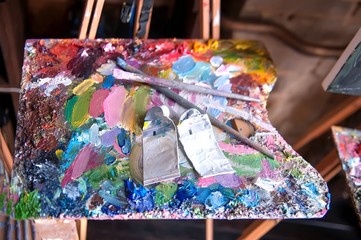 Palette with artists brushes and oil paints