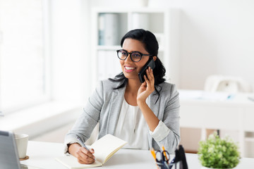 businesswoman calling on smartphone at office