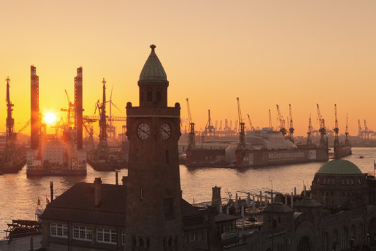St. Pauli Landungsbruecken pier against harbour at sunset, Hamburg, Hanseatic City, Germany
